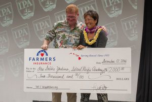 Debbie Yoshino, with Steve Ross, is awarded a check for $2000 from Farmers Insurance.