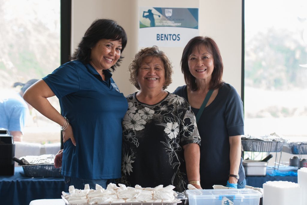 Volunteers prepare the bentos.