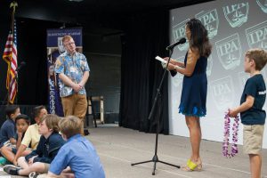 Principal receiving award on stage.