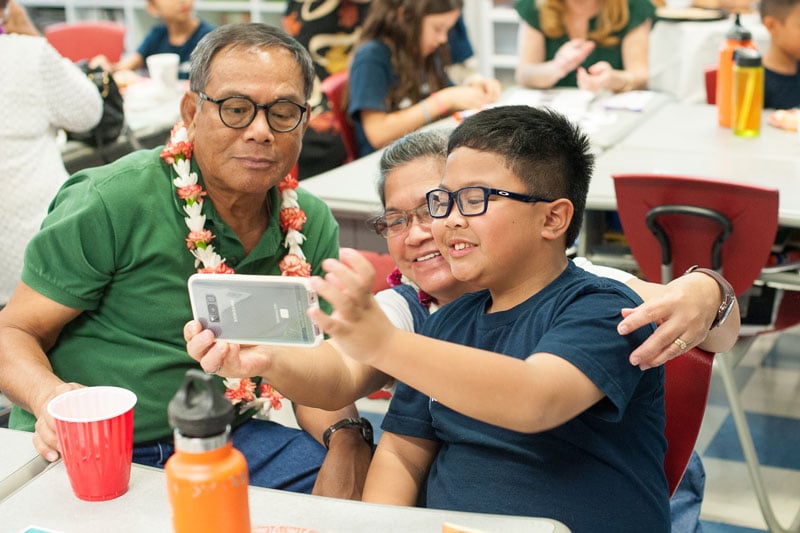 Grade 3 student taking selfie with grandparents