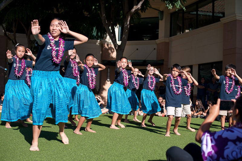 Students dance hula on grass