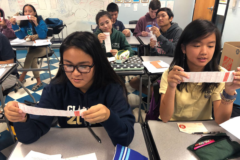 Japanese language students read their fortune strips for the new year