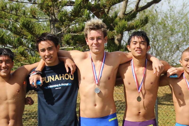 Swimmers with medals around their necks.