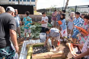 Grade 4 students help to build the umu.