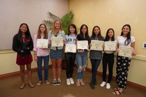 Girlsʻ varsity basketball team with certificates