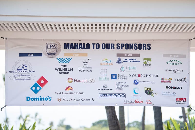 Banner of sponsor logos hanging above registration table