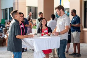 New parents socializing at welcome reception.