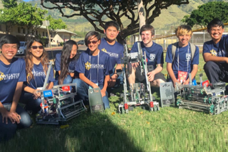 Team photo of the Navigators robotics teams with their robots