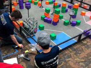 Navigator Robotics team members prep their robot