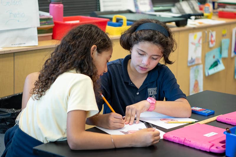 Students collaborate on a math problem.