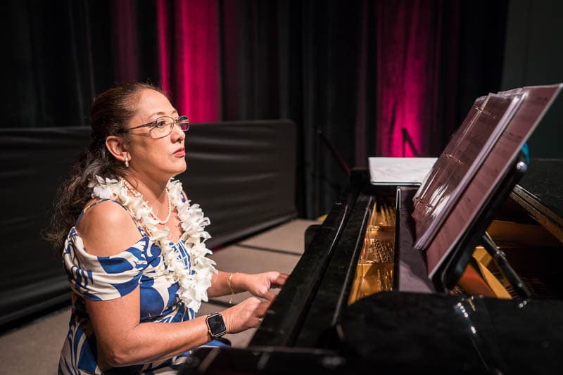 Elementary music teacher Ruth Babas plays piano