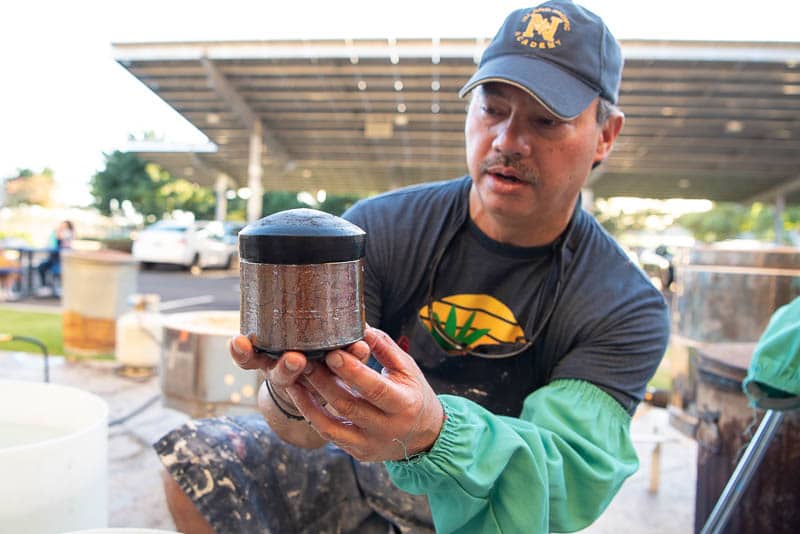 Warren Andrade examines raku fired pot