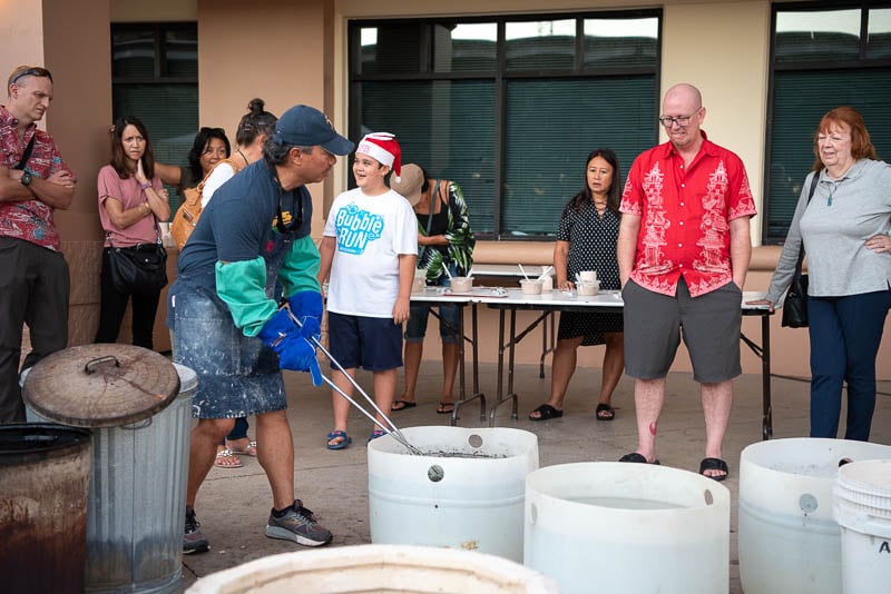 Guests watch ceramic pots come out of kiln