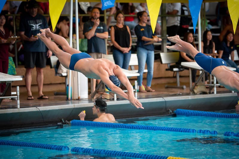 Swimmer diving into pool