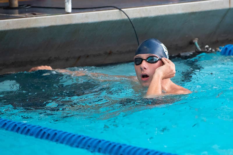 Swimmer removing cap after race