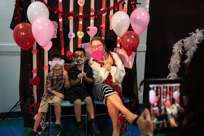 Senior student with kindergarteners at Valentine's dance