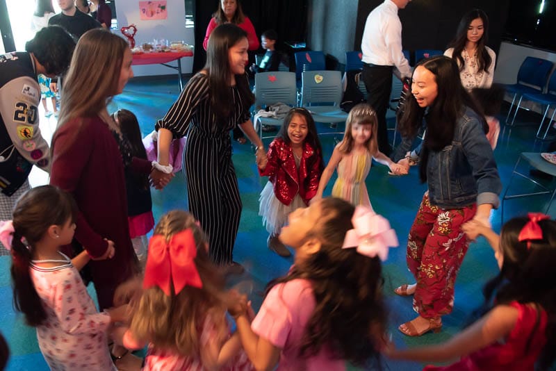 Seniors and kindergarteners dancing in a circle