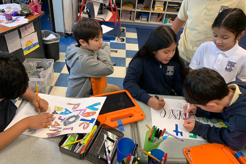 Grade 3 students creating campaign posters