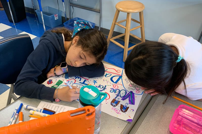 Grade 3 students creating campaign posters