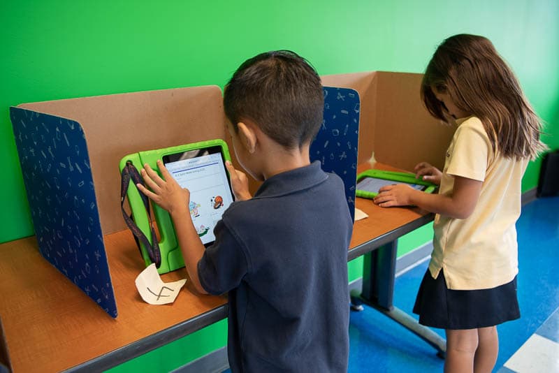 Grade 1 students voting in voting booths