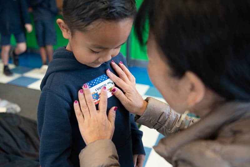 Kindergarten student getting I Voted sticker