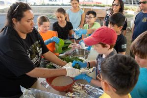 Students helping prepare food for luau