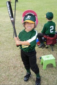 Four year old girl in baseball uniform