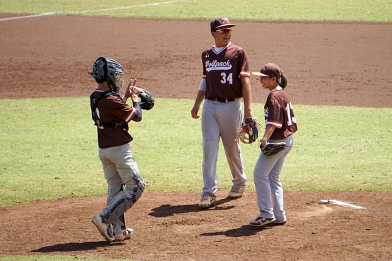 Three middle school infielders on the baseball field