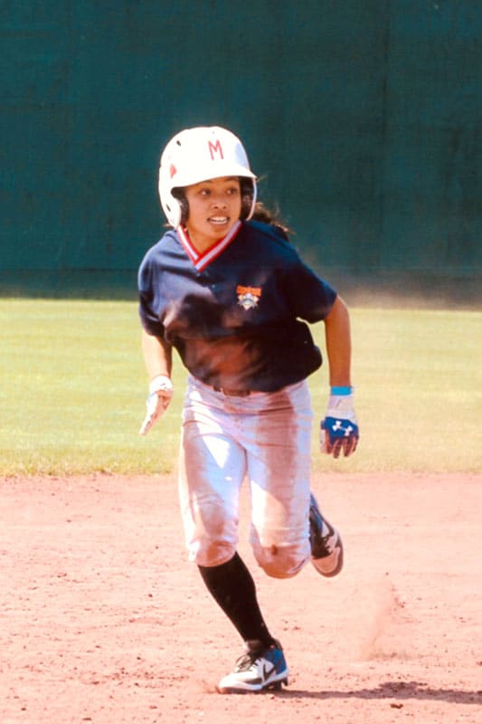 Middle school girl baseball player running the bases