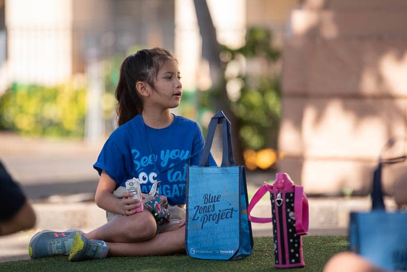 Student on grass enjoying snack