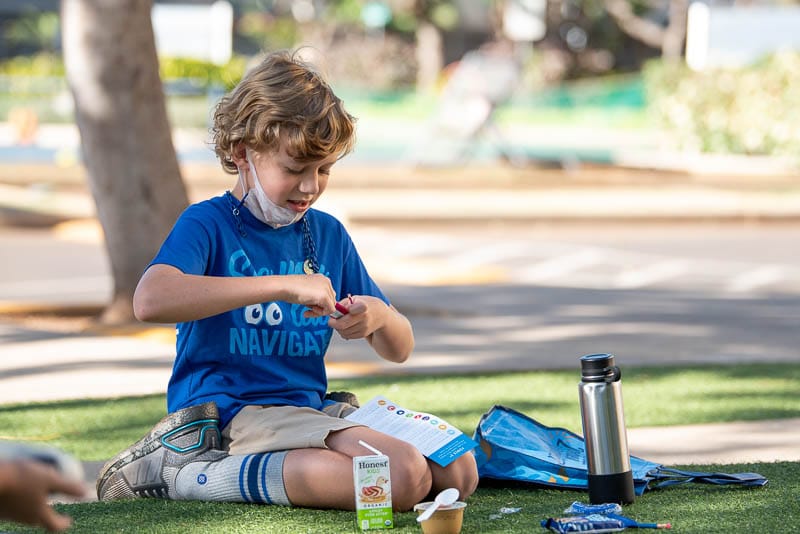 Student enjoying snack on grass