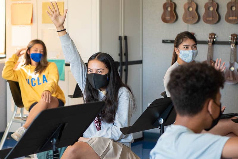 Grade 9 student raising hand.