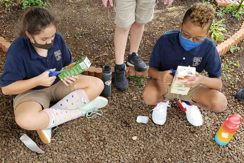 Students preparing containers for garden