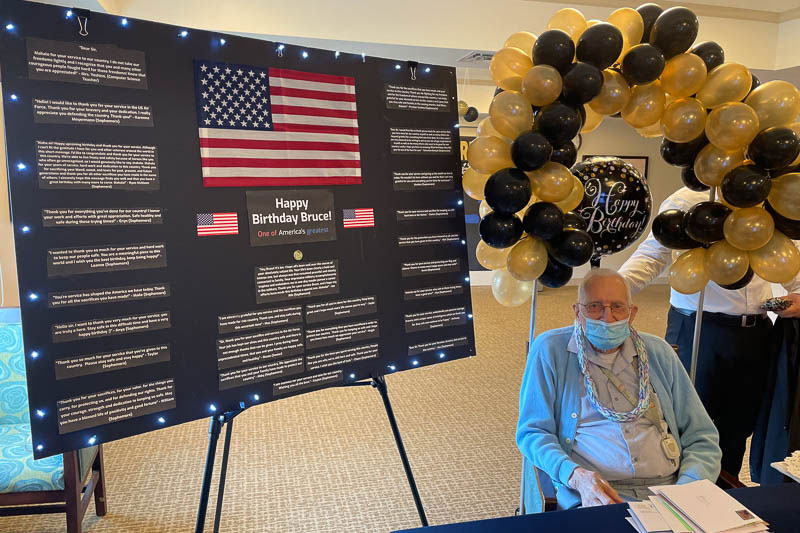 Senior citizen with birthday board