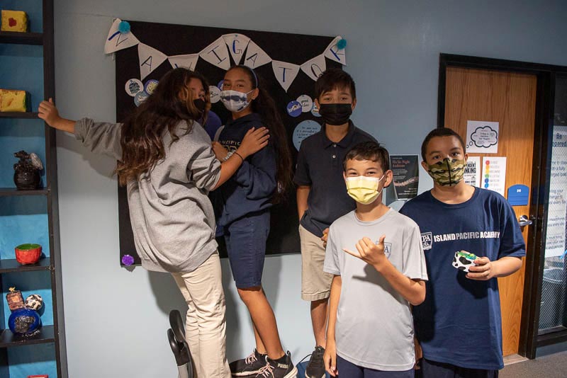 Students around bulletin board