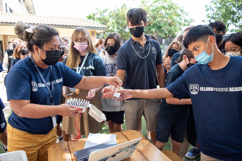 Teacher passing out butterfly envelopes to students