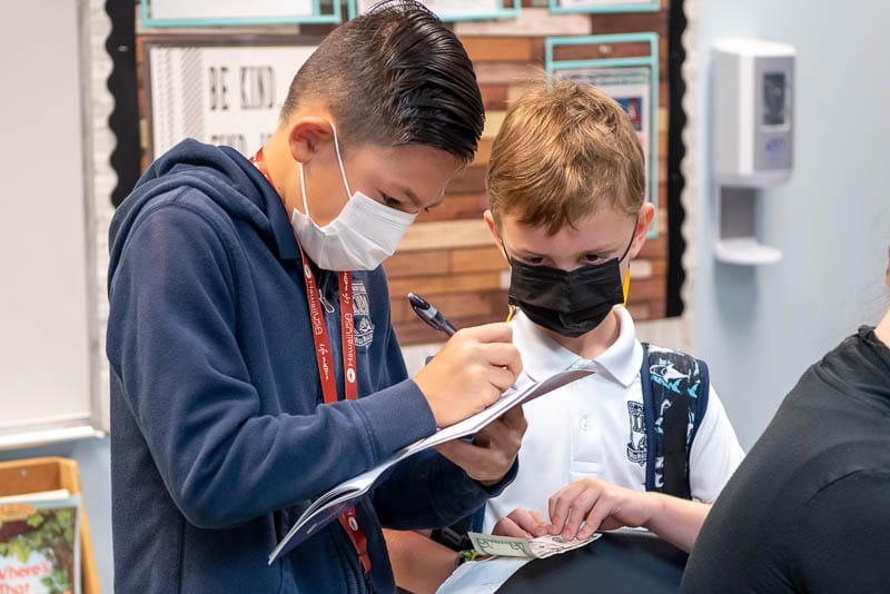 Students assisting credit union member