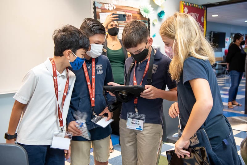 Students looking at iPad