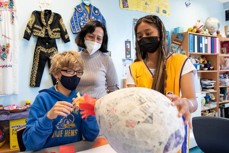 Spanish students making pinata