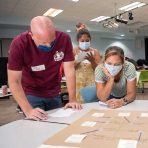 Teachers working together aroumd a table