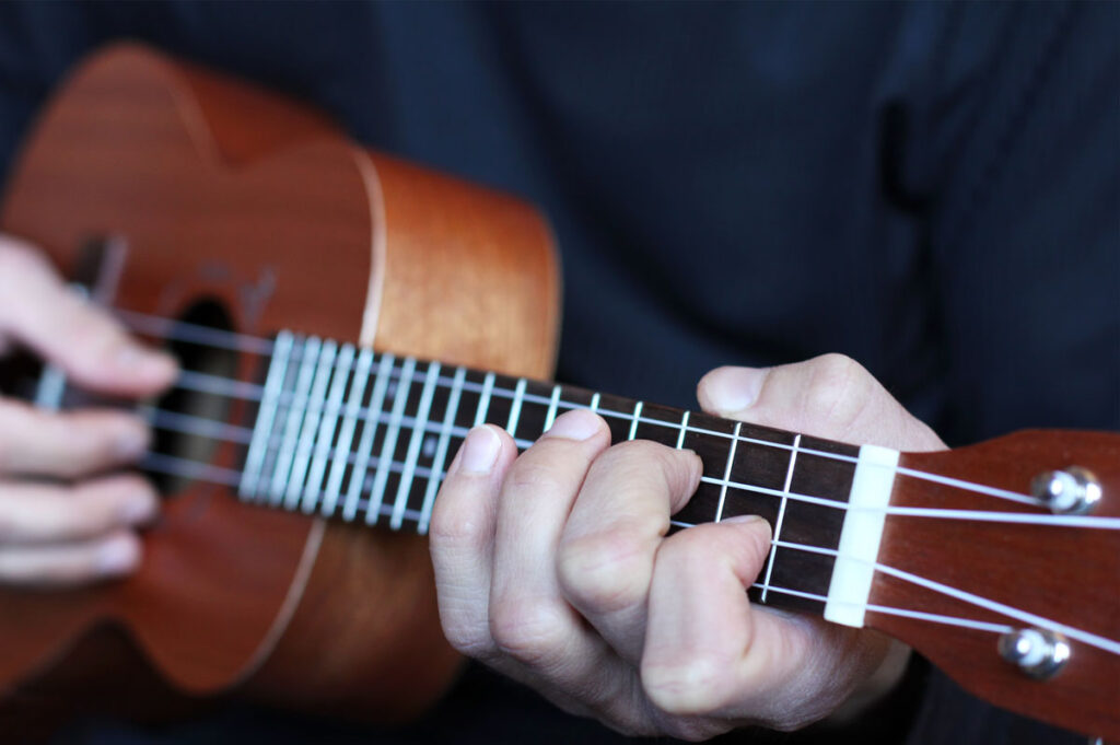 Image of hands playing a Ukelele