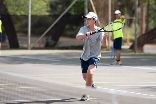 IPA student playing boys tennis