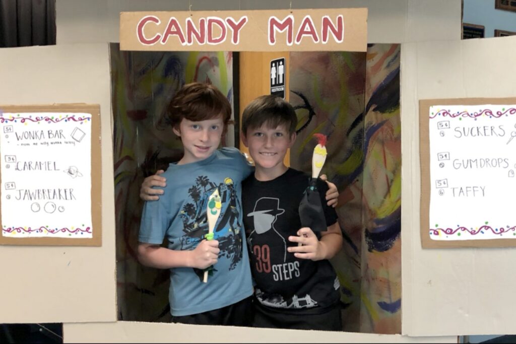 Theatre and drama summer theatre camp with IPA students under a Candy Man sign