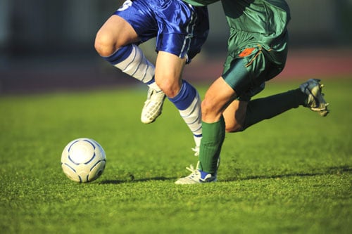 Image of boys kicking soccer ball
