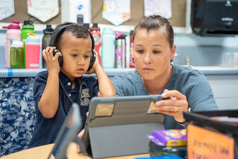 Ipa student with a teacher using an ipad