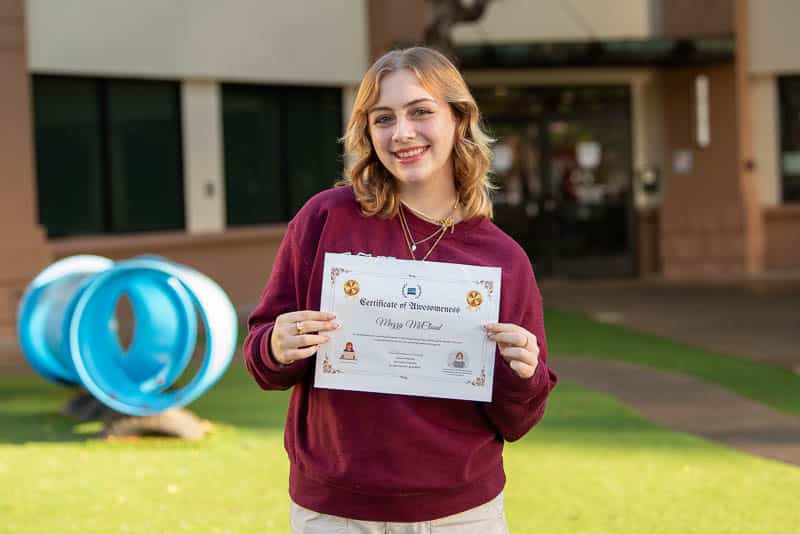 Island Pacific Academy student Mazzy McCloud ʻ25 with the certificate for first place in the 2023 Congressional App Challenge for Hawaiʻiʻs Second Congressional District.