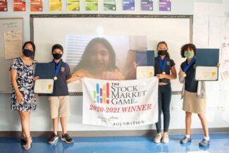 Grade 5 students with awards from The Stock Market Game competition.
